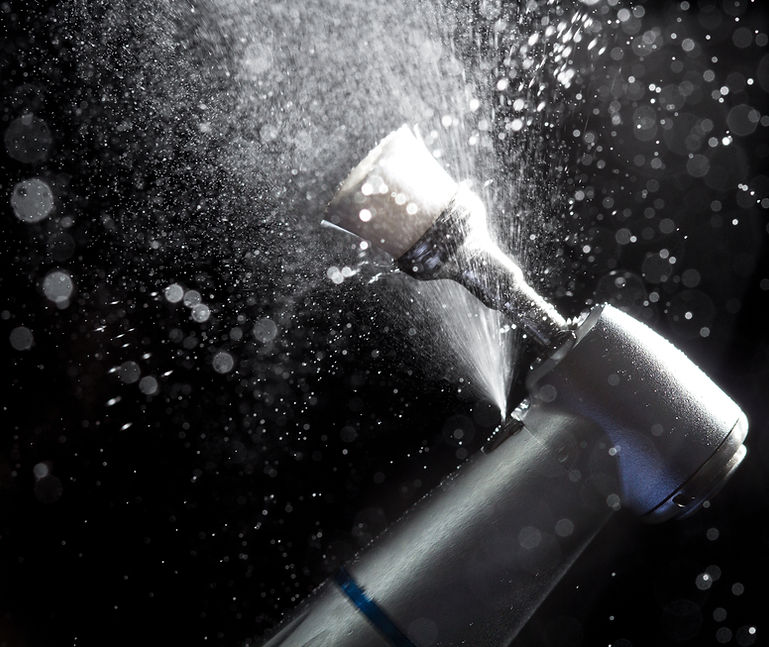 A bottle of champagne is being sprayed with water, adding a touch of dental hygiene to the sparkling Hampstead celebration.