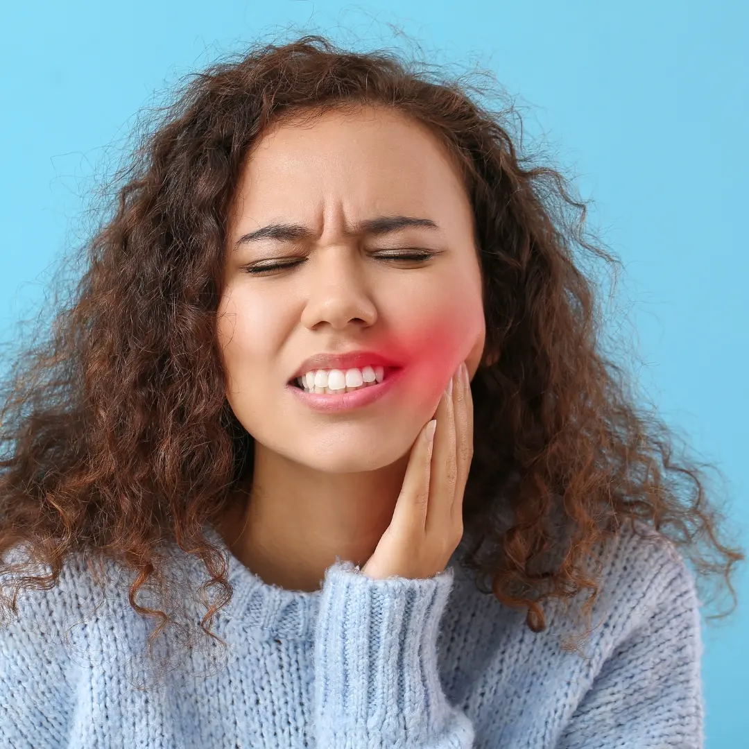 A woman with a toothache on blue background.
