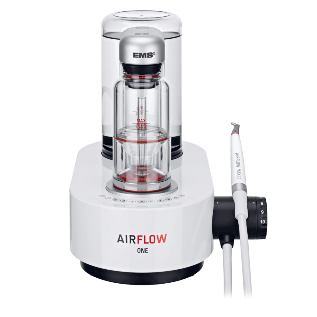 A white EMS AIRFLOW ONE dental device with a transparent water chamber and attached handpiece, used for professional teeth cleaning.